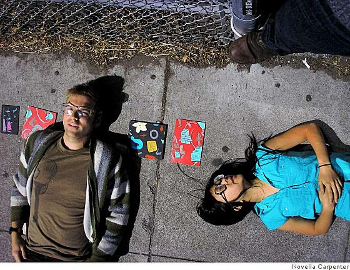 Artists Crockett Bodelson and Sandra Wang sell their paintings on the sidewalk to passersby in Hayes Valley.
