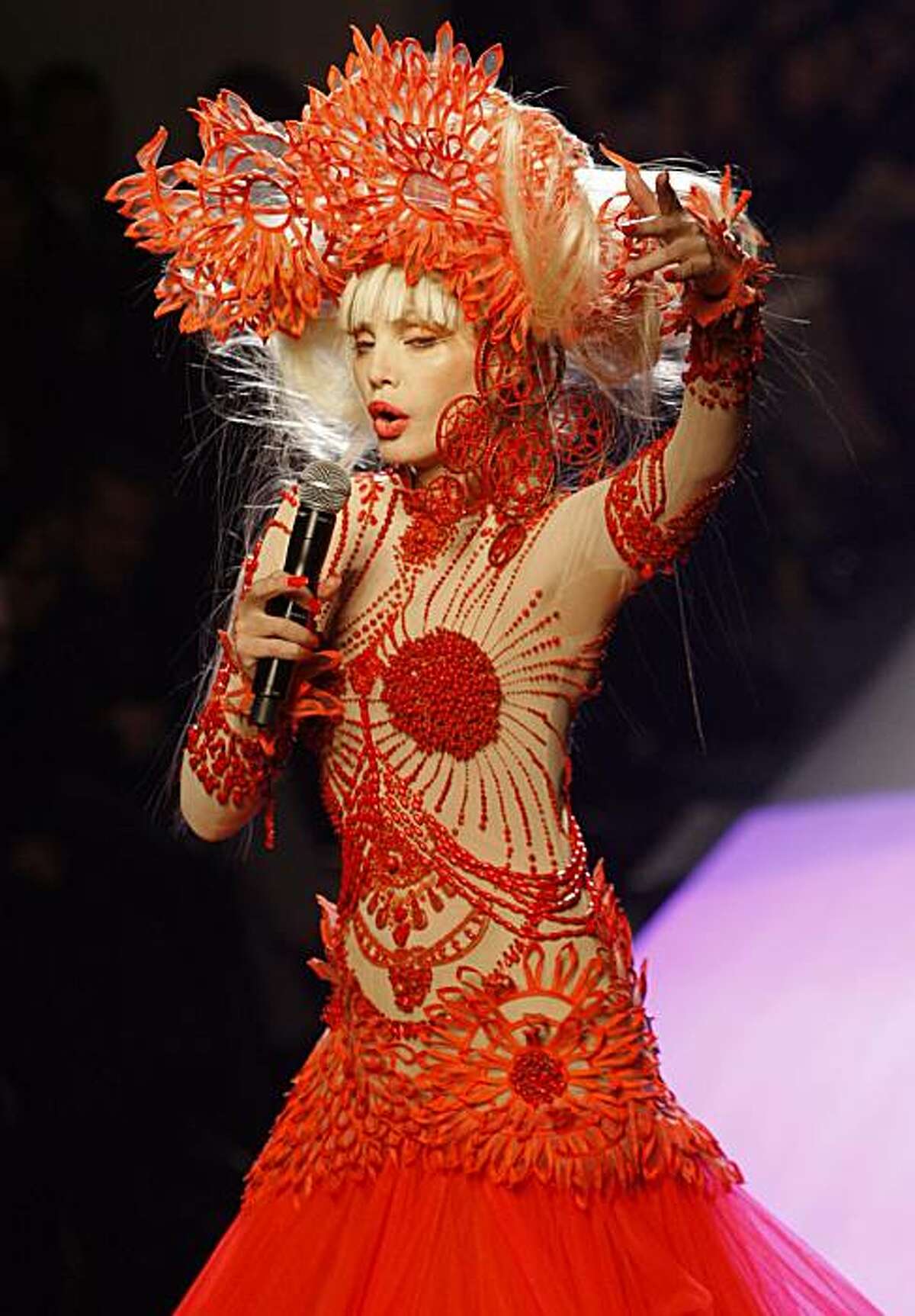 French actress Arielle Dombasle presents a creation by French designer Jean-Paul Gaultier as part of his Haute Couture Spring Summer 2010 fashion collection in Paris, Wednesday, Jan. 27, 2010.