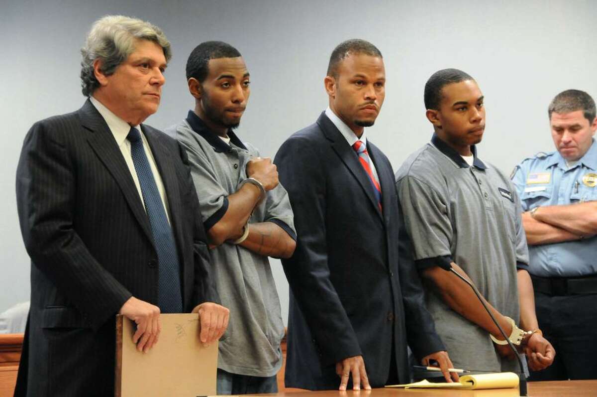 Prior to being individually arraigned, John William Lomax III, right, accompanied by his attorney Deron Freeman, second right, and Hakim Muhammad, with his attorney Gerald Klein, far left, appear for their arraignment before a Superior Court judge with regard to charges connected with the slaying of UConn football player Jasper Howard, in a courtroom at Rockville Superior Court, in Rockville, Conn., on Wednesday, Oct. 28, 2009. (AP Photo/George Ruhe)