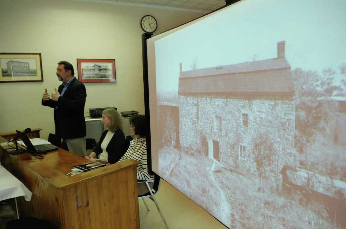 John Bonafide, far left, addresses those gathered at the Ravena Village Hall on Sunday, Jan. 15, 2012 in Ravena, NY. as a photograph of the Coeymans Manor Home is seen on the screen. In May 2008, a contractor at the historic Coeymans house found a woman's skull while working on a basement wall and on Sunday researchers spoke to the public on their best guesses of who the person was. (Paul Buckowski / Times Union)