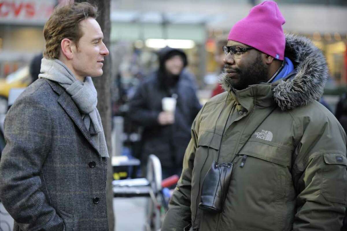 Actor Michael Fassbender, left, and writer/director Steve McQueen discuss a scene on the set of Shame.