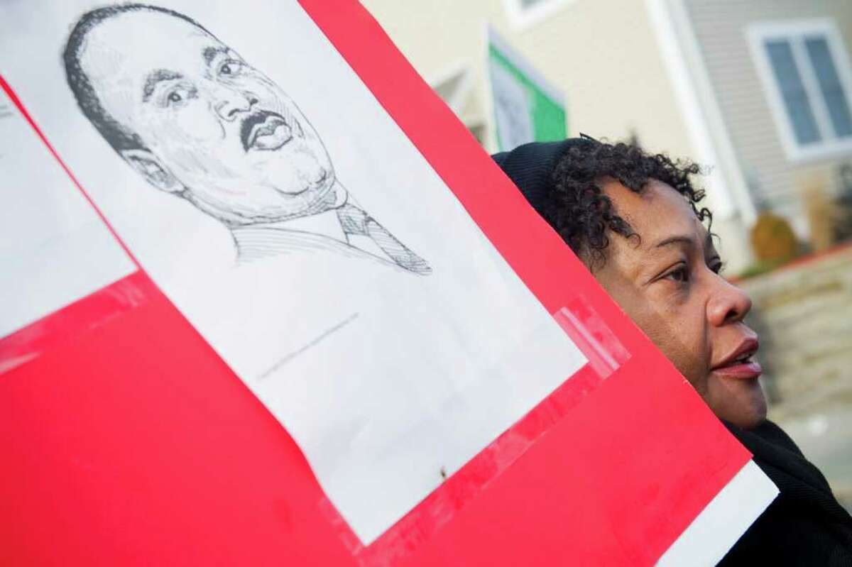 Geraldine Miller holds the image of Martin Luther King during a march from Bethel AME Church on Fairfield Avenue through downtown Stamford and ending at the Yerwood Center in Stamford, Conn., January 16, 2012.