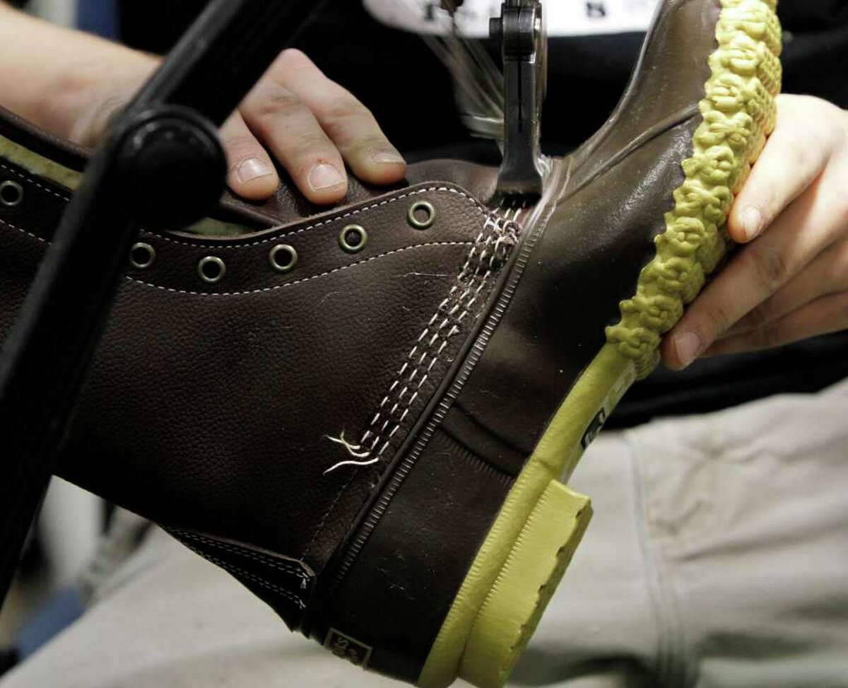 In this Dec. 14, 2011 photo, an L.L. Bean boot is stitched at the facility where L.L. Bean boots are assembled in Brunswick, Maine. L.L. Bean's famed hunting boots are seeing a surge in popularity, necessitating the hiring of more than 100 additional employees to make them.