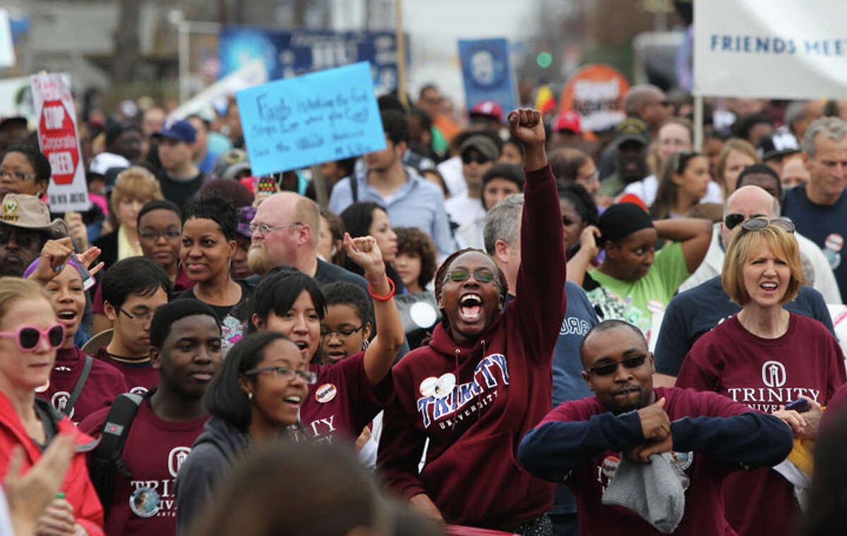 Trinity University students (bottom, foreground) take part in the Martin Luther King, Jr. March as marchers come close to Pittman Sullivan Park.