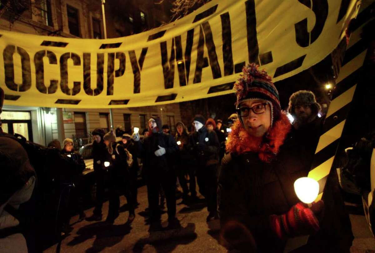Participants, including Occupy Wall Street protesters, march and take part in a candlelight vigil to honor Rev. Martin Luther King, Jr. in New York, Sunday, Jan. 15, 2012. The march started at Cathedral Church of Saint John the Divine, ending at nearby Riverside Church where a ceremony took place with speeches, song and poetry honoring the civil right leader. (AP Photo/Craig Ruttle)