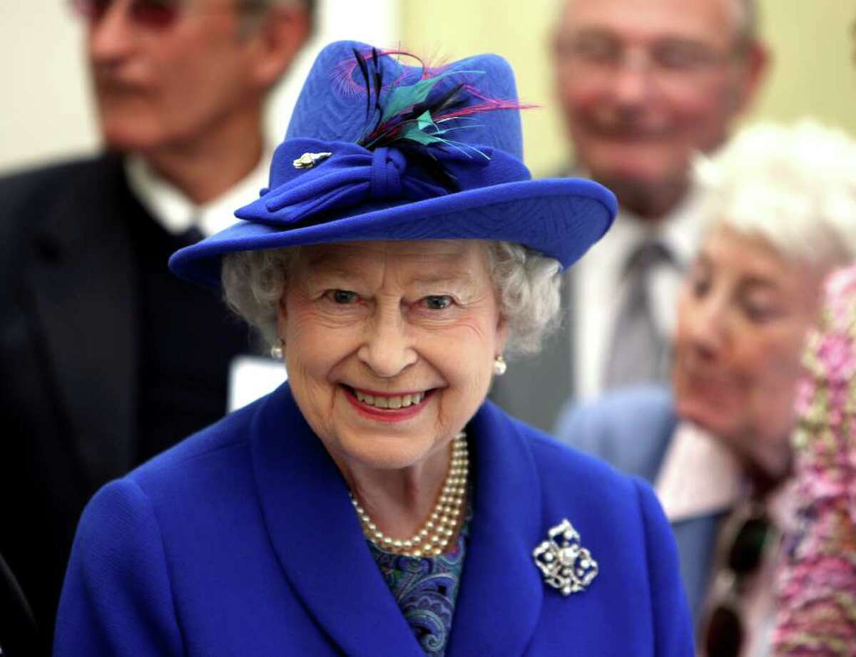 TO GO WITH YEAR-2011-BRITAIN-ROYALS BY ROBIN MILLARD (FILES) In a file picture taken on May 3, 2011 Britain's Queen Elizabeth II smiles as she visits the Newmarket Day Centre. Queen Elizabeth II's diamond jubilee in 2012 should put the icing on an "annus mirabilis" for the British royals during which the world watched Prince William's wedding to Kate Middleton. AFP PHOTO / POOL / CHRIS RADBURN (Photo credit should read Chris Radburn/AFP/Getty Images)