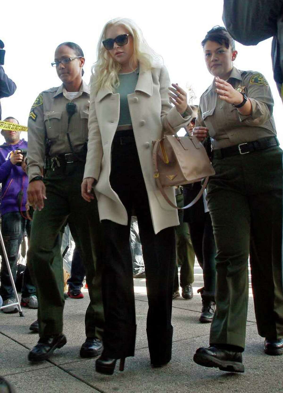 Lindsay Lohan arrives at Los Angeles Superior Court for a probation progress hearing Tuesday, Jan. 17, 2012. Lohan remains on probation for convictions in a 2007 drunken driving case and a grand theft case in 2011. (AP Photo/Reed Saxon)