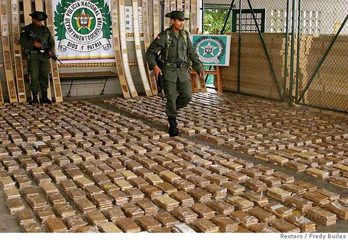A Colombian anti drugs policeman walks amid a cocaine load confiscated in the Caribbean port of Cartagena, Colombia, November 22, 2005. Colombian police seized at least 821 kgs of cocaine bound for Mexico. REUTERS/Fredy Builes Ran on: 12-07-2005 A Colombian antidrug officer walks amid more than 1,800 pounds of cocaine seized at the port of Cartagena last month. Ran on: 12-07-2005 A Colombian antidrug officer walks amid more than 1,800 pounds of cocaine seized at the port of Cartagena last month.