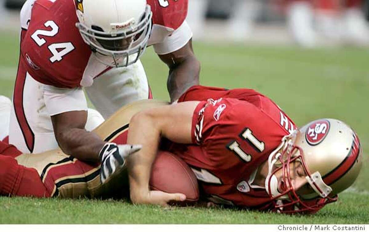 49ers quarterback gets tackled by Cardinals strong safety Adrian Wilson in the second half. 49ers lose to the Arizona Cardinals as Monster Park. Event on 12/04/05 in San Francisco Photo: Mark Costantini /San Francisco Chronicle
