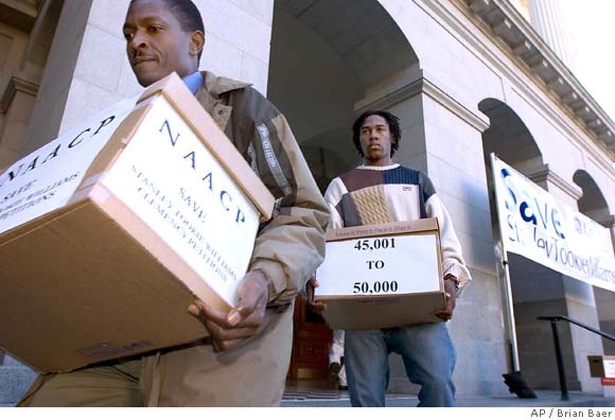 Ariemba Momanyi , left and Vincent Payne, carry some of the thousands of signed clemency petitions the NAACP delivered to California Gov. Arnold Schwarzenegger in Sacramento, Calif., part of an attempt to save death row inmate Stanley Tookie Williams, Tuesday, Dec. 6, 2005. Williams, co-founder of the Crips gang in Los Angeles, was convicted of killing four people in two 1979 robberies. He is scheduled to be executed Dec. 13. (AP Photo/The Sacramento Bee, Brian Baer) ** MANDATORY CREDIT **