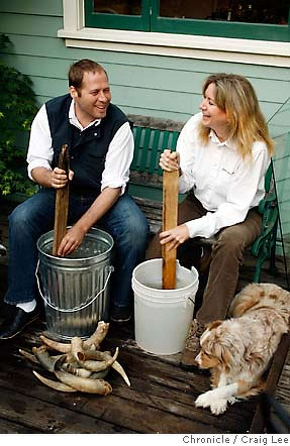 BIODYNAMIC16_046_cl.JPG Story on chefs who have their own biodynamic farms to supply their restaurant. This is David Kinch, chef at Manresa in Los Gatos. David and his farmer, Cynthia Sandberg of Love Apple Farm in Ben Lomond, apply a biodynamic preparation to the crops. Photo of Cynthia Sandberg (right) and David Kinch (left) stirring rain water captured in buckets to make the biodynamic preparation. Cynthia's dog, Indy, is on the right. Event on 4/27/07 in Ben Lomond. photo by Craig Lee / The Chronicle MANDATORY CREDIT FOR PHOTOG AND SF CHRONICLE/NO SALES-MAGS OUT
