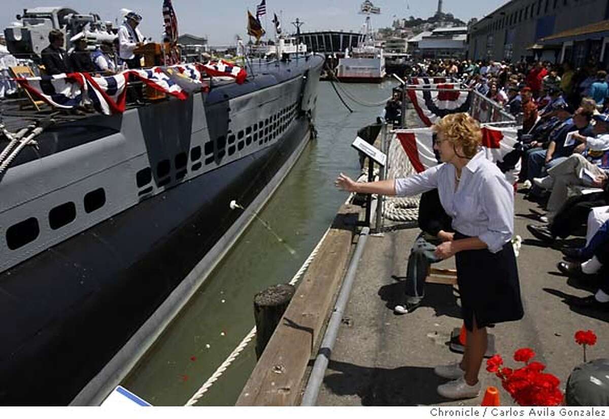 MEMORIAL29_004_CAG.JPG Barbara North of Concord, drops a carnation into the SF Bay waters in memory of the 65 subs and their crews that did not make it back from combat. Members of the United States Submarine Veterans tolled a bell 65 times as more than 200 submarine veterans gathered on Memorial Day, Monday, May 28, 2007, aboard the USS Pampanito submarine, to honor the men and the 65 sumbarines that never returned. This "lost Boat" ceremony, memorializing the 65 submarines on eternal patrol, took place at Pier 45 in San Francisco, Ca. Photo by Carlos Avila Gonzalez/The Chronicle Photo taken on 5/28/07, in San Francisco, Ca, USA. **All names cq (source)