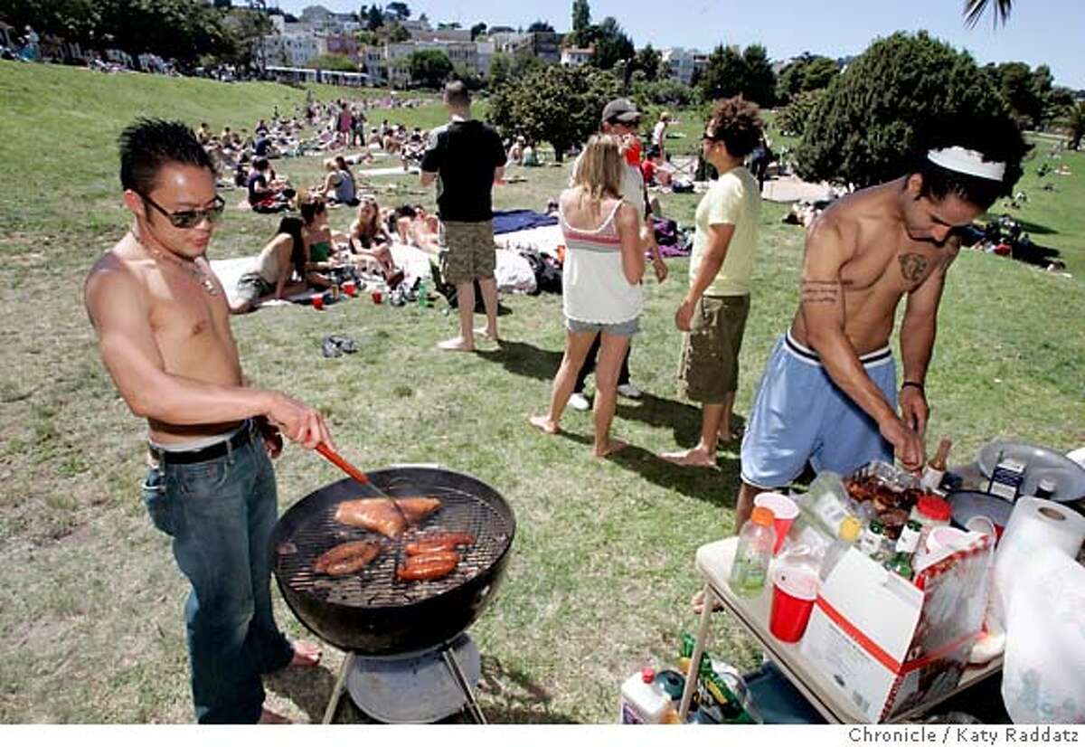 PICNIC23_DOLORES_026_RAD.jpg SHOWN: L: Anton Gaskell mans the grill, and R: Joshua Brooks checks supplies. They are at a large picnic that they and their fellow Redwood Room employees are enjoying at Dolores Park. For Urban Picnic story, we go to Dolores Park. These pictures were made in San Francisco, CA. on Sunday, May 6, 2007. (Katy Raddatz/The Chronicle) **Anton Gaskell, Joshua Brooks Mandatory credit for the photographer and the San Francisco Chronicle. No sales; mags out.