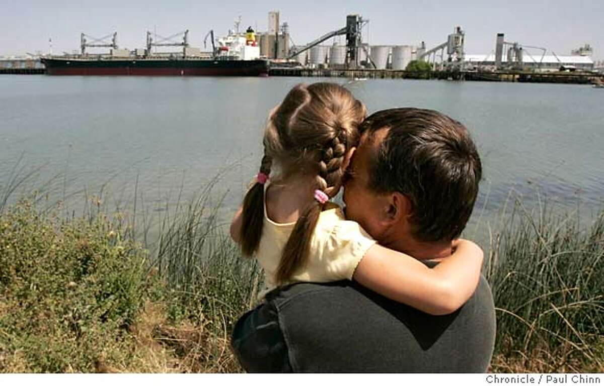 Alex Zavgorodnev brought his five-year-old daughter Victoria to the port to whale watch. Two wayward humpback whales continue to swim at the Port of Sacramento in West Sacramento, Calif. on Thursday, May 17, 2007. Marine biologists are hoping to lure the giants back towards the Pacific Ocean with whale sounds. PAUL CHINN/The Chronicle **Alex Zavgorodnev, Victoria