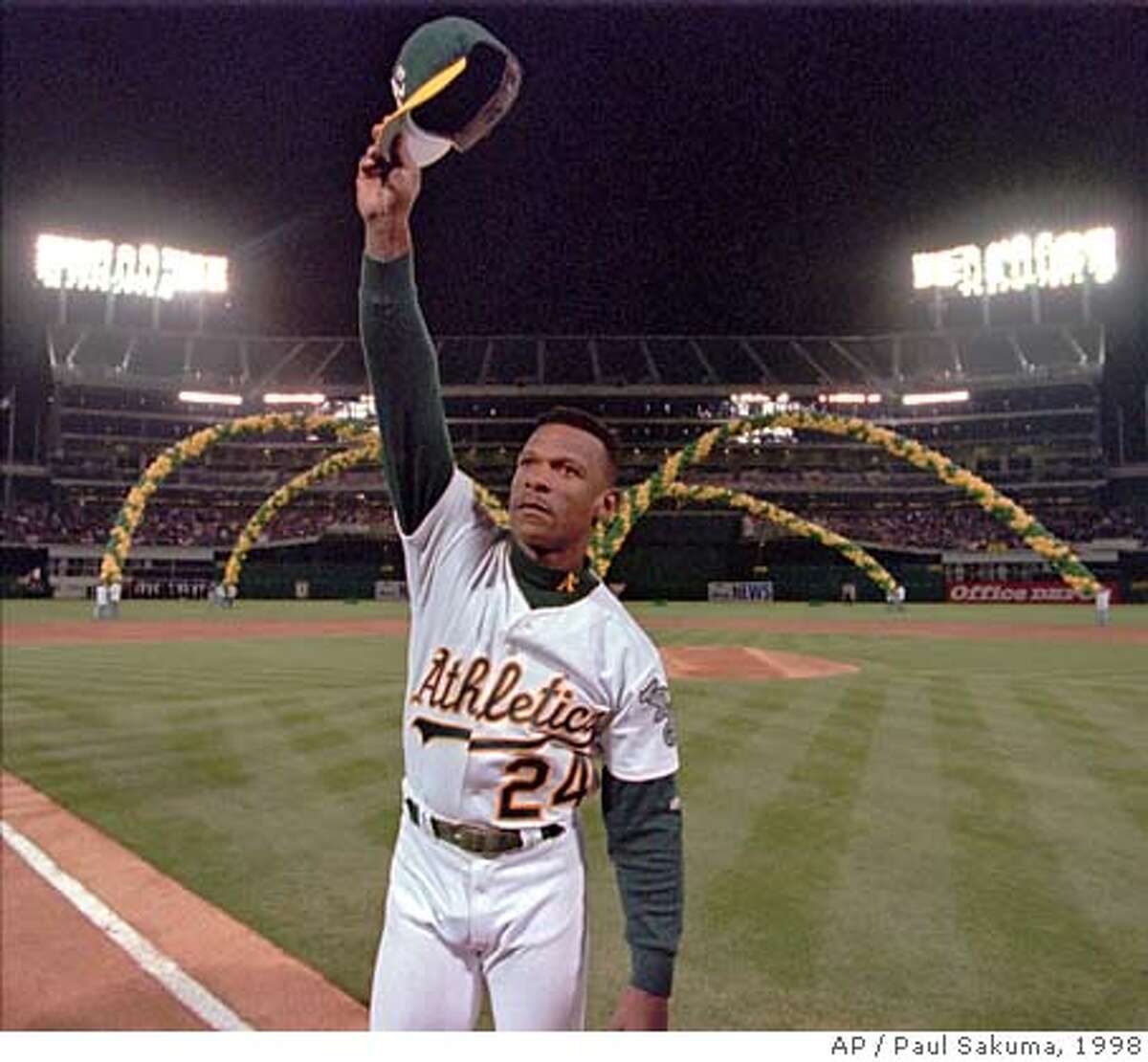 Oakland Athletics left fielder Rickey Henderson waves to the crowd as he is introduced before the game against the Boston Red Sox, Wednesday night, April 1, 1998, at the Oakland (Calif.) Coliseum. (AP Photo/Paul Sakuma)