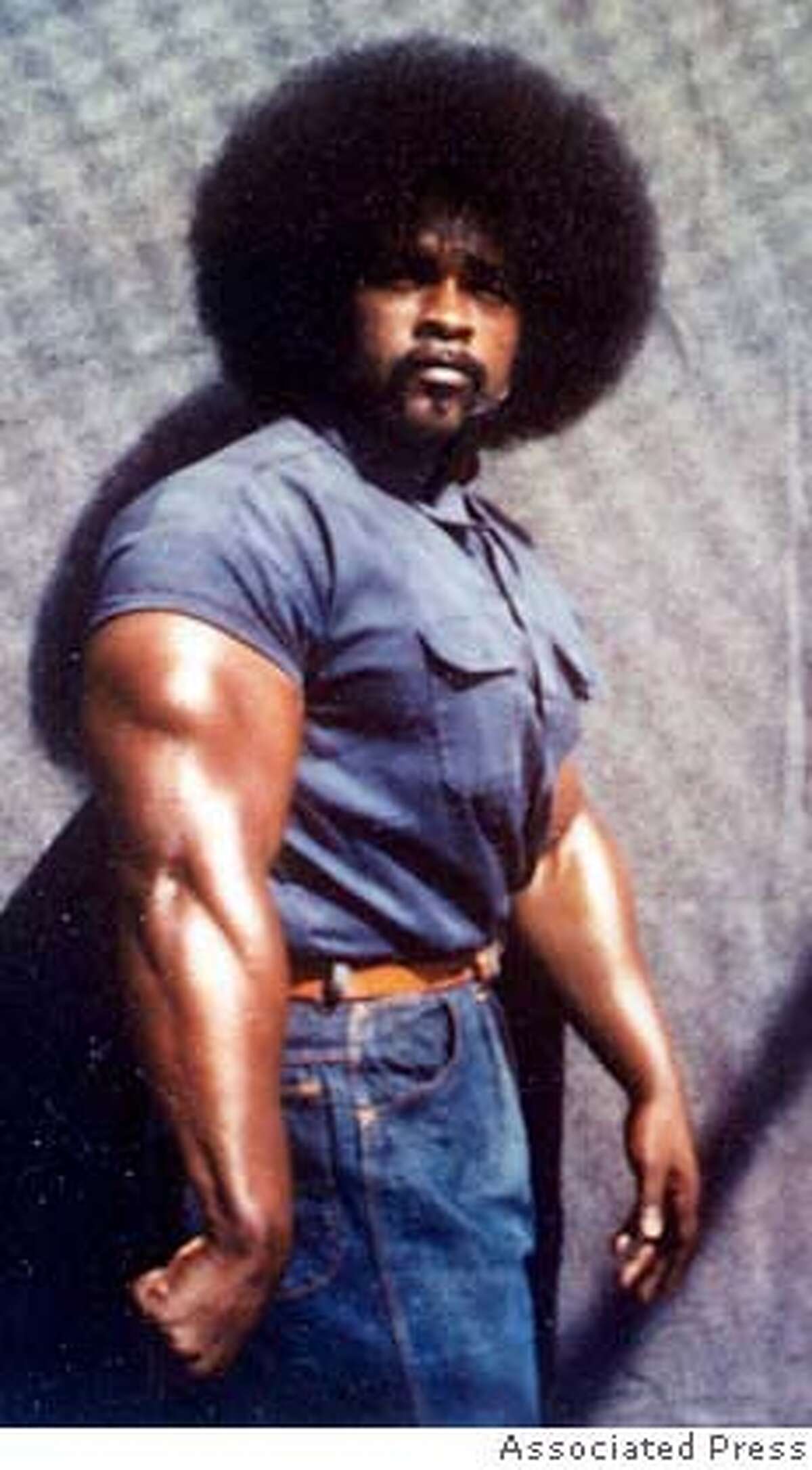 ** FILE ** In this undated file photo, Stanley "Tookie" Williams poses at age 29 in the exercise yard at San Quentin Prison. Williams, a founder of the notorious Crips street gang, is scheduled to be executed next month and is asking Gov. Arnold Schwarzenegger for clemency. A 13-page petition seeking to save the life of Stanley "Tookie" Williams was delivered to the governor today. (AP Photo/Courtesty of Williams Family, File) UNDATED HANDOUT