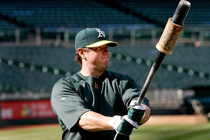 Oakland Athletics' Jack Cust gets a high five after hitting a two