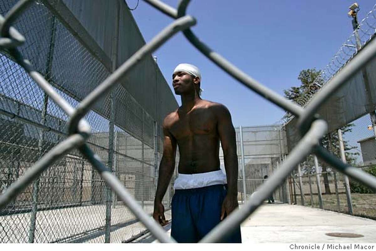juvenilejustice2_275_mac.jpg John Horton, 24, from Watts, Ca., has been incarcerated since the age of 16 and is kept inside metal fenced cages hwere he is allowed to spend about 3 hours a day. He is kept isolated because of racially motivated attacks on other wards. In 53 days he will be set free when he reaches the age of 25. Wards as young as 16 years of age begin serving time at Stark Youth Correctional. Many complete their entire sentences here some getting out at the age of 25 which are the oldest prisoners can be held at Stark. A visit to the Heman G. Stark Youth Correctional Facility in Chino, Ca. Photographed in, Chino, Ca, on 4/10/07. Photo by: Michael Macor/ The Chronicle Mandatory credit for Photographer and San Francisco Chronicle No sales/ Magazines Out