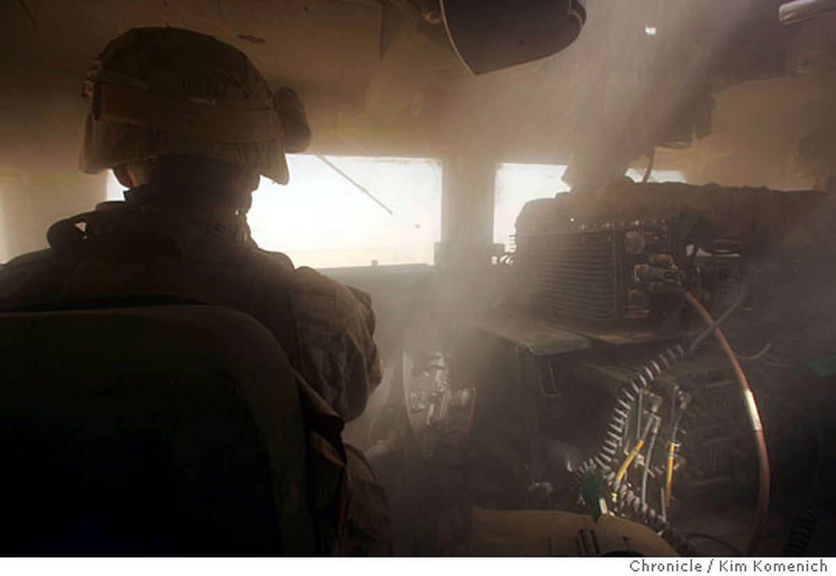 Light streams through the gunner's turret into the powder-fine dust that has crept into the humvee on desert roads to Camp Belleau Wood. In our first full day reporting, we are taken by Marines from the 1st Mobile Assault Platoon, Weapons Company, 3rd Battalion, 6th Marines Regiment to neighborhoods near the Euphrates River at the Syrian border, where there is major insurgent action. San Francisco Chronicle Photo by Kim Komenich 9/27/05