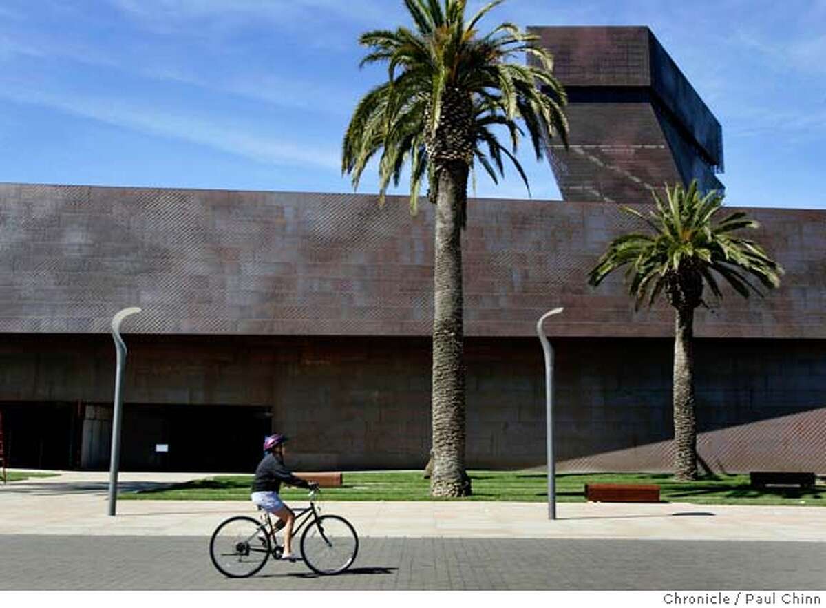 deyoung06_083_pc.jpg A bicyclist pedals past the main entrance and tower. Exterior views of the new de Young Museum in Golden Gate Park on 10/5/05 in San Francisco, Calif. PAUL CHINN/The Chronicle MANDATORY CREDIT FOR PHOTOG AND S.F. CHRONICLE/ - MAGS OUT