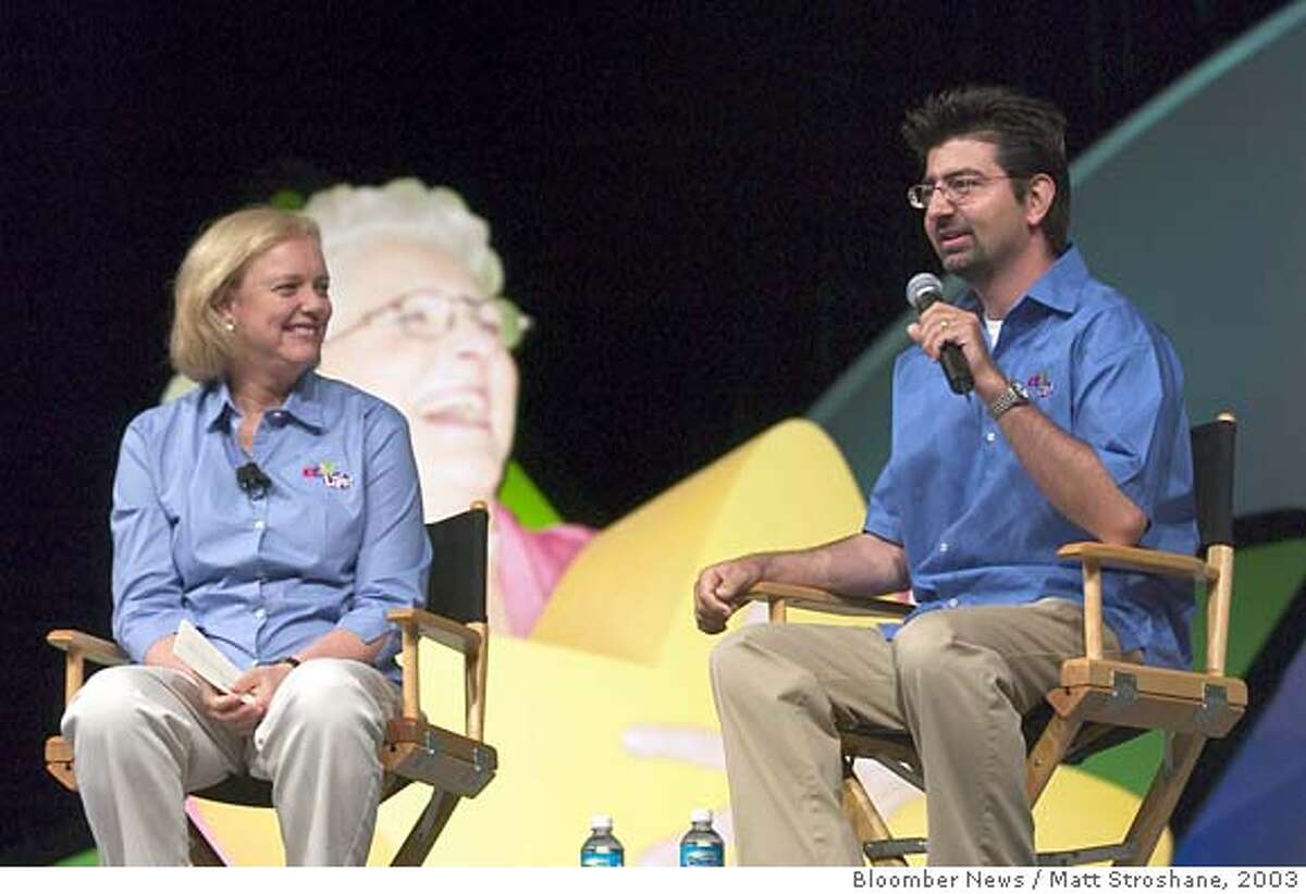 Meg Whitman, president and CEO of eBay, left, looks on as Pierre Omidyar, founder and chairman of eBay, speaks at the 2nd annual eBay Live! Community Conference in Orlando, Florida on June 27, 2003. EBay has been one of the most successful survivors of the dot-com boom and bust by focusing on boosting sales, getting rid of unprofitable operations such as Butterfields, a fine-art auctioneer, and buying its biggest rival in payment processing. Photographer: Matt Stroshane / Bloomber News.