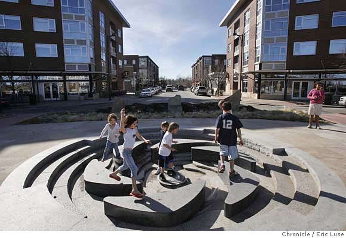 urbandesign_stapleton_0449_el.JPG The Founder's Green is meant to be a gathering place. Kids turn these water fountains (turned off for winter) into a creative playground with the small town center behind them. Stapleton community at the old site of the Denver airport is a diverse mix of home styles. Photographer: Eric Luse / The Chronicle names cq from source MANDATORY CREDIT FOR PHOTOG AND SF CHRONICLE/NO SALES-MAGS OUT