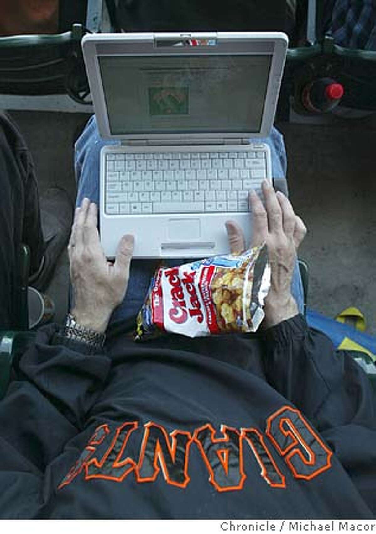 Richard Hilleman of San Mateo takes his mini-laptop to the game to follow along with the statistics and check other scores of other games. WiFi Internet access now available to fans who take in a Giants game at SBC Park here in San Francisco. event on 4/22/04 in San Francisco Michael Macor / San Francisco Chronicle
