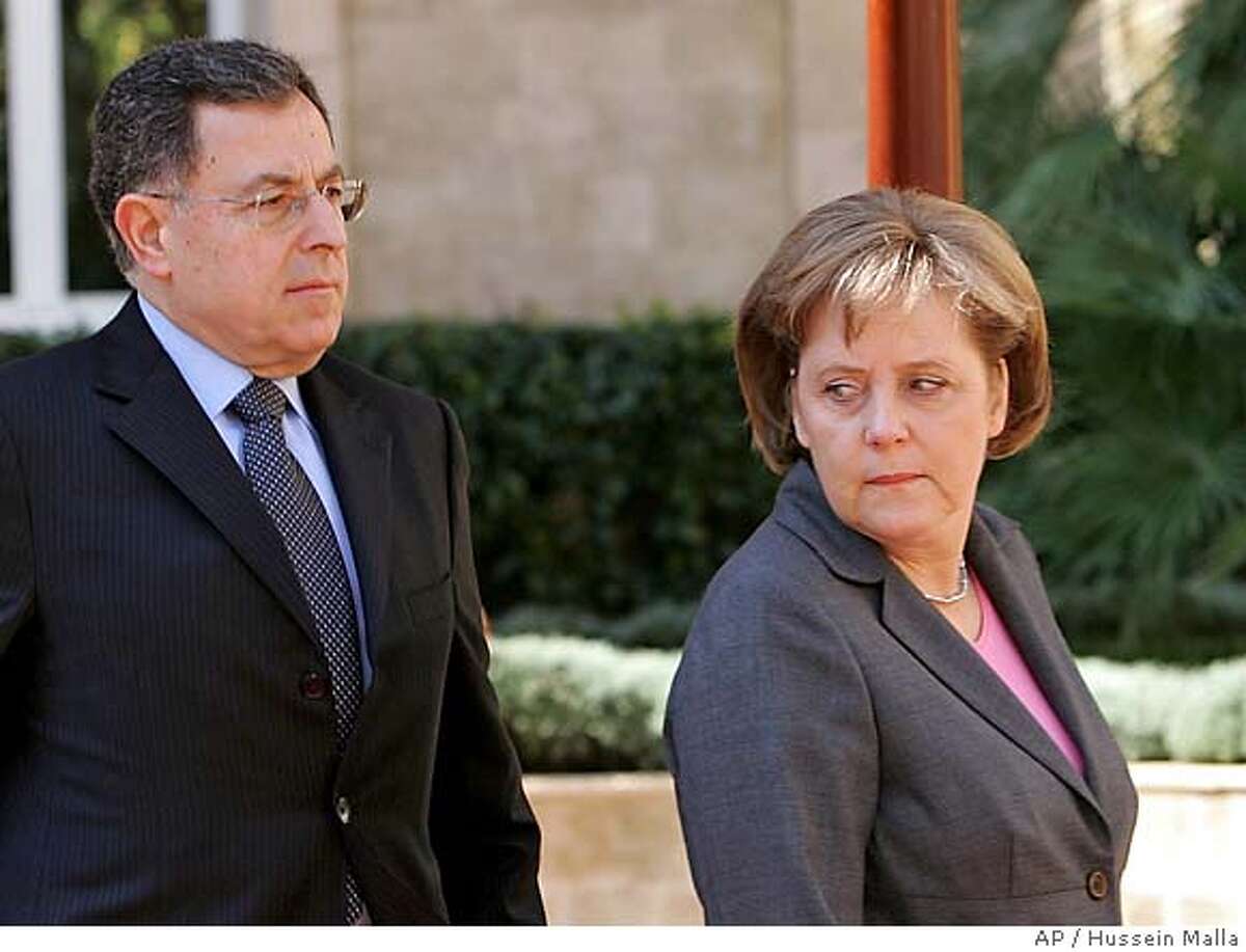 German Chancellor Angela Merkel, right, looks on as she heads to the Government House accompanied by Lebanese Prime Minister Fuad Saniora in Beirut, Lebanon Monday, April 2, 2007. Merkel arrived in Beirut Monday for talks with Lebanese leaders and to inspect a German naval task force serving with a U.N. peacekeeping force in Lebanon. (AP Photo/Hussein Malla)