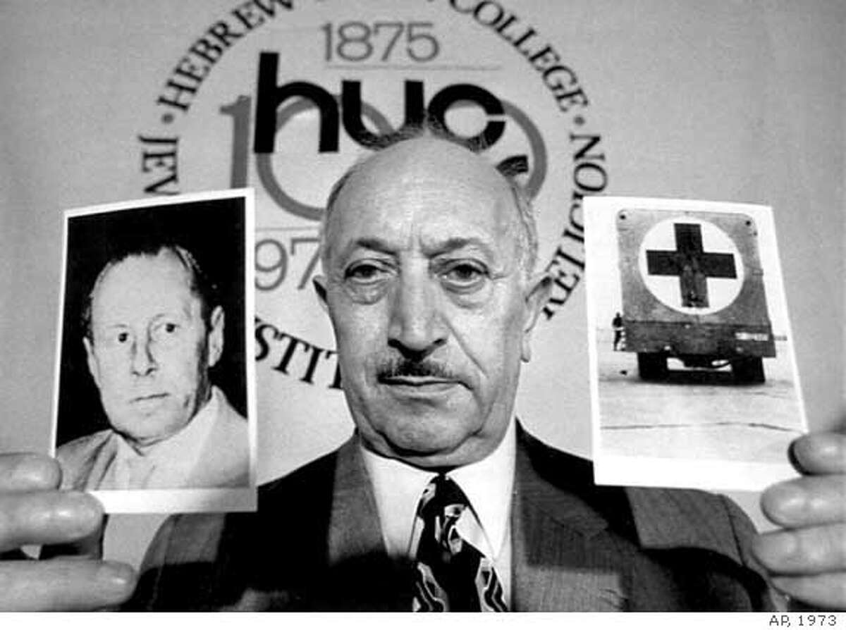 ** FILE ** Simon Wiesenthal displays two pictures, May 31, 1973, which he says refer to Nazi criminal Walter Rauff, during a news conference at the Hebrew Union College in New York City. Wiesenthal, the Holocaust survivor who helped track down numerous Nazi war criminals following World War II then spent the later decades of his life fighting anti-Semitism and prejudice against all people, died Tuesday Sept. 20, 2005. He was 96. Wiesenthal died in his sleep at his home in Vienna, Austria, according to Rabbi Marvin Hier, the dean and founder of the Simon Wiesenthal Center in Los Angeles. (AP-PHOTO)