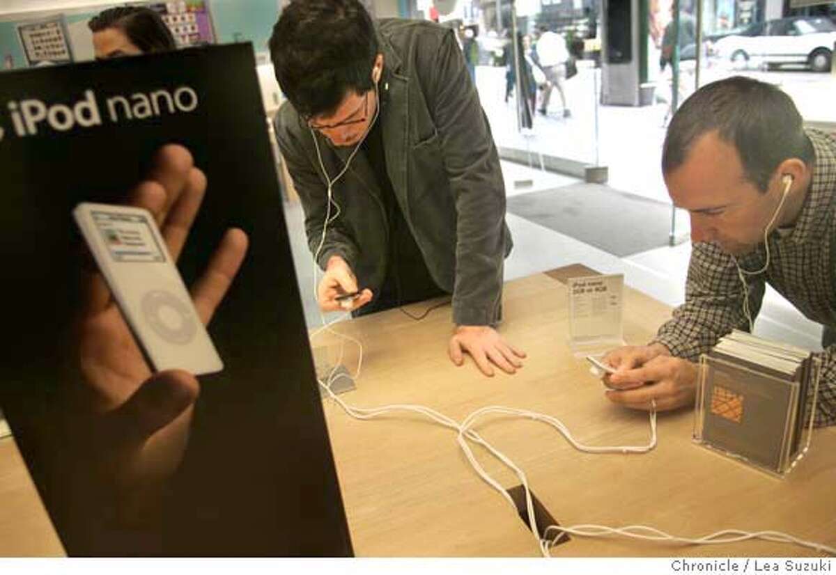ipod031_ls.JPG from left: Gareth Spor of Berkeley and Mark McKechnie of San Francisco check out Apple Computer Inc.'s new iPod Nano at the Apple store. Apple Computer Inc.'s new iPod Nano is creating a buzz, one that design consultants is indicative of the way the Cupertino company has transcended technology and made the iPod a lifestyle/pop culture product. Shoot people using buying etc the Nano and a tight shot of it from various angles and any signage, advertising, etc. Photo taken on 9/14/05 in San Francisco, CA. Photo by Lea Suzuki/ The San Francisco Chronicle