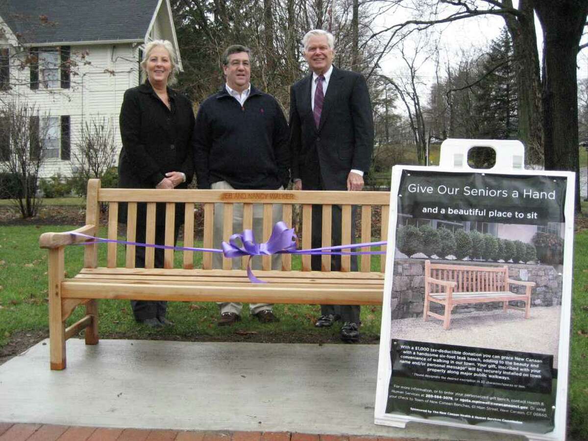 First Selectman Rob Mallozzi, center, accepts 19 new teak benches for townís seniors. Pictured with Mallozzi are Director of Health & Human Services Carol McDonald and Chairman of Health & Human Service Commission Jim Lisher.