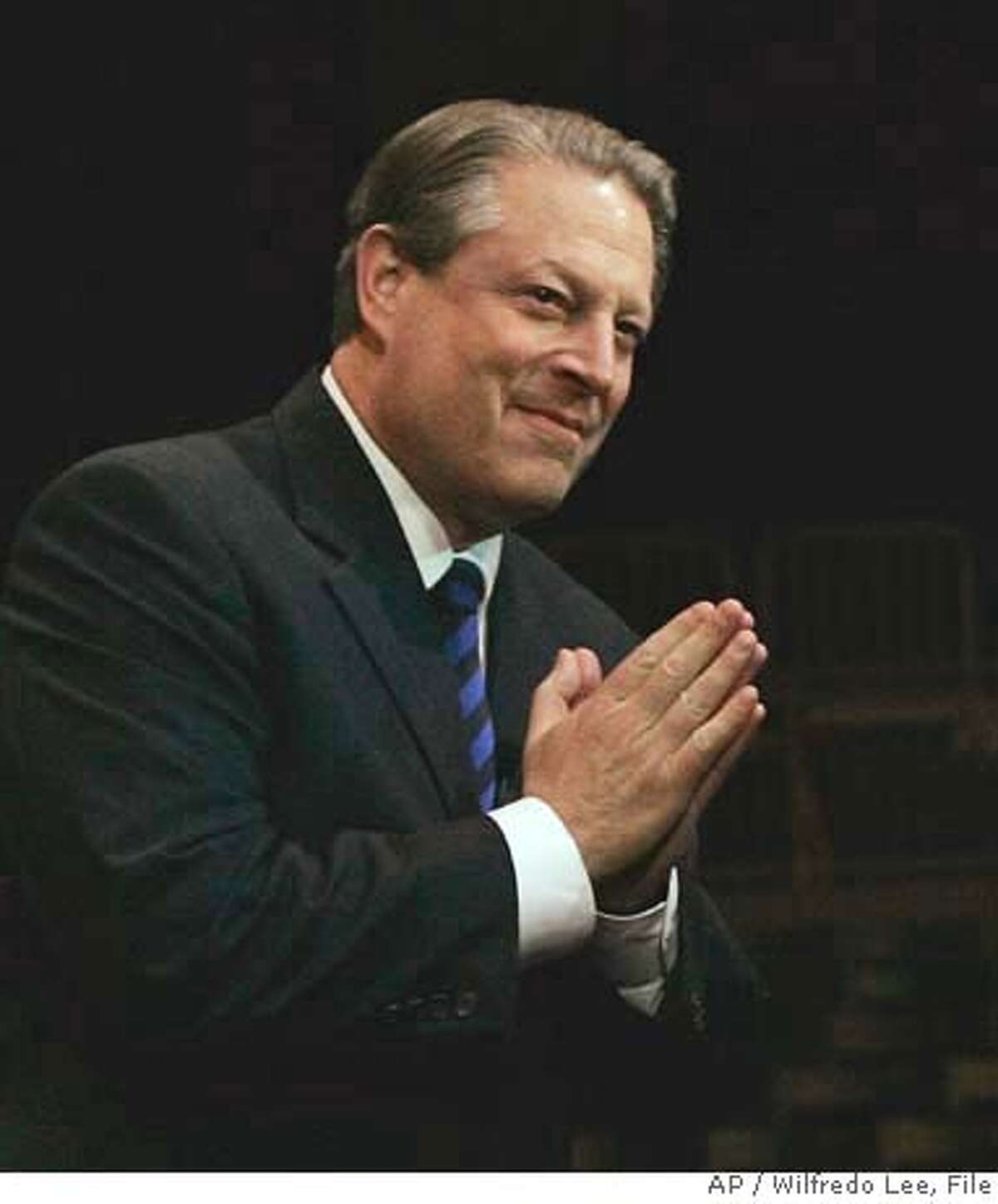 **FILE** Former Vice President Al Gore acknowledges the crowd in this file photo from Feb. 28, 2007, before giving a multimedia version of his book and Academy Award-winning documentary "An Inconvenient Truth," at the University of Miami in Coral Gables, Fla. An airline employee led the former vice president and two associates around airport security lines before police spotted the breach and required them to be screened, an airport spokeswoman said Thursday, March 1, 2007. (AP Photo/Wilfredo Lee-File) FILE PHOTO FROM FEB. 28, 2007