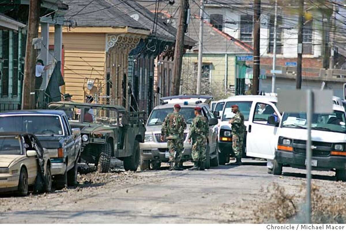 katrina12_289_mac.jpg A Coroner Team makes a stop along St. Anthony St. in the 7th Ward District of New Orleans to recover a body that has been inside a home for the past two weeks. The aftermath of Hurricane Katrina that ravaged New Orleans, Louisiana. 9/12/05 New Orleans , La Michael Macor / San Francisco Chronicle Mandatory Credit for Photographer and San Francisco Chronicle/ - Magazine Out