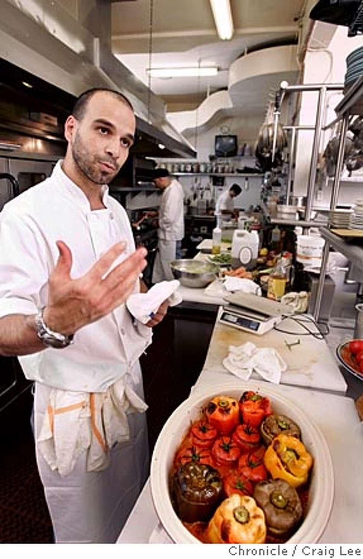 Photo of Mourad Lalou with his dish of Ground Beef and Lamb Stuffed Bell Peppers with Tomato Sauce. Cooking with Moroccan chef, Mourad Lalou at his restaurant, Aziza at 5800 Geary Blvd. at 22nd. Story on Moroccan trinity of ingredients: tomatoes, eggplant and peppers. Event on 8/9/05 in San Francisco. Craig Lee / The Chronicle