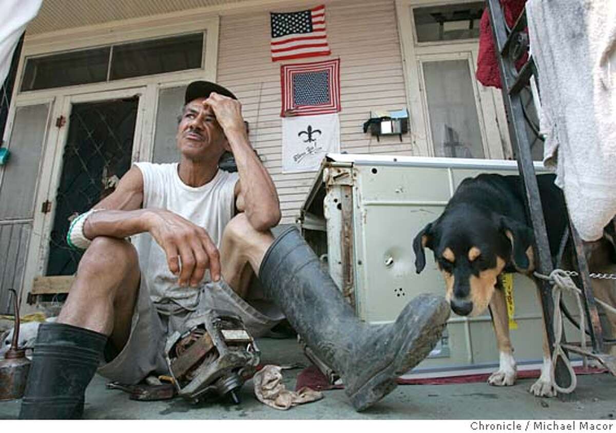 John Deigle, whose home is in the Bywater District, once had 2 feet of water in his home, the water has since receeded, he now is going through his appliances fixing the motors because of water damage. His dog Sparky close by. The aftermath of Hurricane Katrina that ravaged New Orleans, Louisiana. 9/10/05 New Orleans , La Michael Macor / San Francisco Chronicle