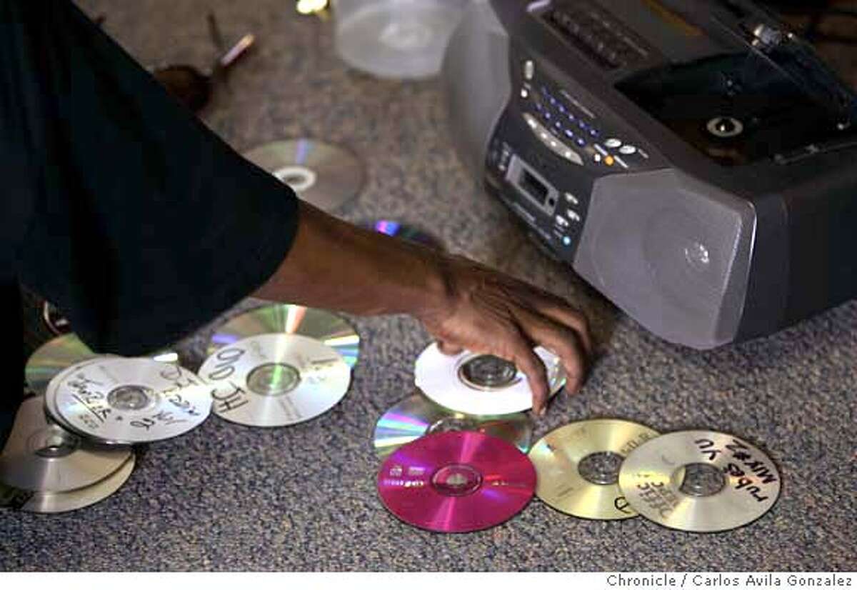ARCHITECKZ_009_CAG.JPG Jeriel Bey of the dance group Architeckz, sifts through his collection of music cds as he teaches his dance techniques to students at Berkeley High School on Thursday, March 8, 2007. The group, founded in West Oakland in 2002, is on the cutting edge of an effort to channel the energy of young people into non-violent activities through turf dancing, in which groups try to outdo each other in a modern version of break dancing. On Sunday, March 11th, Architeckz will face off against a turf dancing team from Memphis in a fundraiser for youth programs in Oakland. Photo by Carlos Avila Gonzalez/The San Francisco Chronicle Photo taken on 3/8/07, in Berkeley, Ca, USA. **All names cq (source) MANDATORY CREDIT FOR PHOTOG AND SAN FRANCISCO CHRONICLE/NO SALES-MAGS OUT