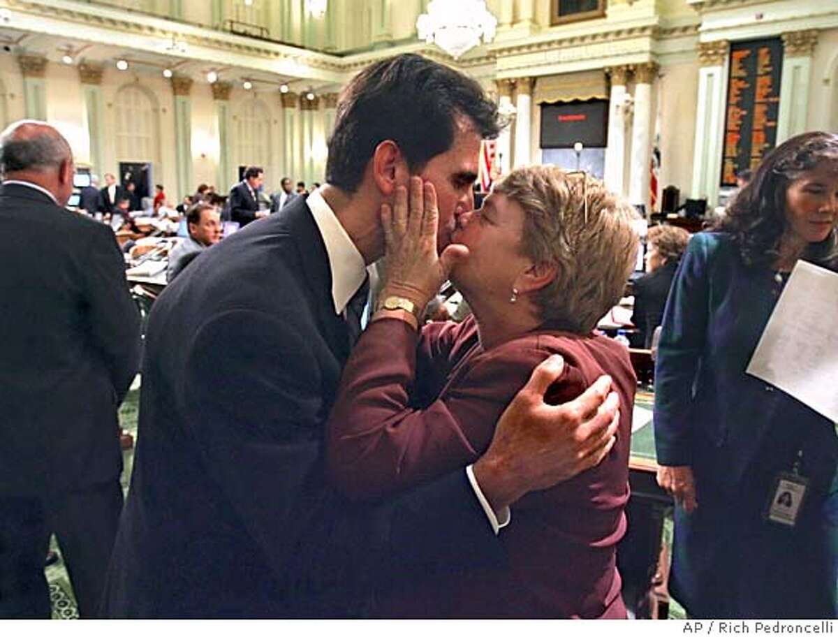 Assemblyman Mark Leno, D-San Francisco, left, gets a kiss from state Sen. Sheila Kuehl, D-Santa Monica, after his same-sex marriage measure was passed by the Assembly at the Capitol in Sacramento, Calif., Tuesday, Sept. 6, 2005. The California Legislature became the first legislative body in the U.S. to approve same-sex marriages, as gay-rights advocates overcame two earlier defeats in the Assembly. The 41-35 vote sends the bill to Gov. Arnold Schwarzenegger, whose office had no comment on the bill when it cleared the state Senate last week. (AP Photo/Rich Pedroncelli)