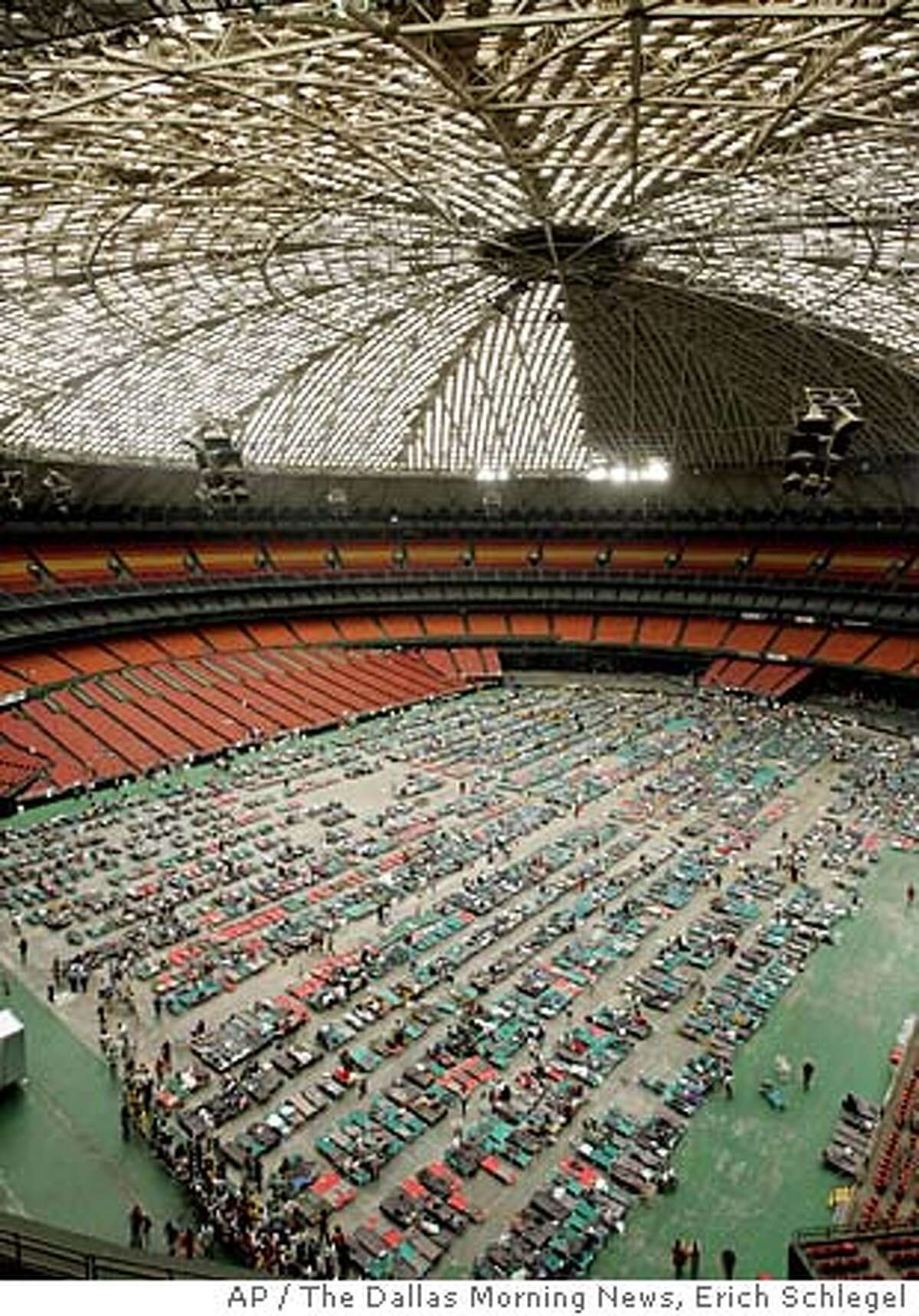 Hurricane Katrina refugees begin to fill up cots on the floor of the Astrodome Thursday, Sept. 1, 2005, in Houston. According to Red Cross volunteers, 5,000 refugees from Louisiana had arrived inside the Astrodome by Thursday afternoon. (AP Photo/The Dallas Morning News, Erich Schlegel)