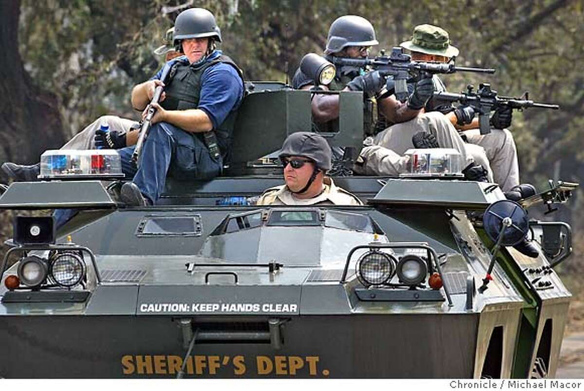 Members of the Louisiana Sheriffs Task Force, on patrol through the streets of the Uptown neighborhood north of downtown New Orleans. The aftermath of Hurricane Katrina that ravaged the gulf coast states, with New Orleans, Louisiana taking the brunt of the killer storm. 9/3/05 New Orleans , La Michael Macor / San Francisco Chronicle