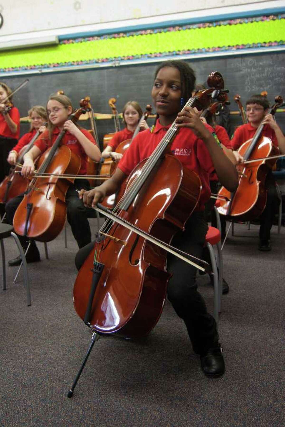 Cellist Myah McNair, 10, and other fifth-grade members of the Parker Elementary School ensemble practice. The group is raising funds to attend a Suzuki Association conference in May in Minneapolis.