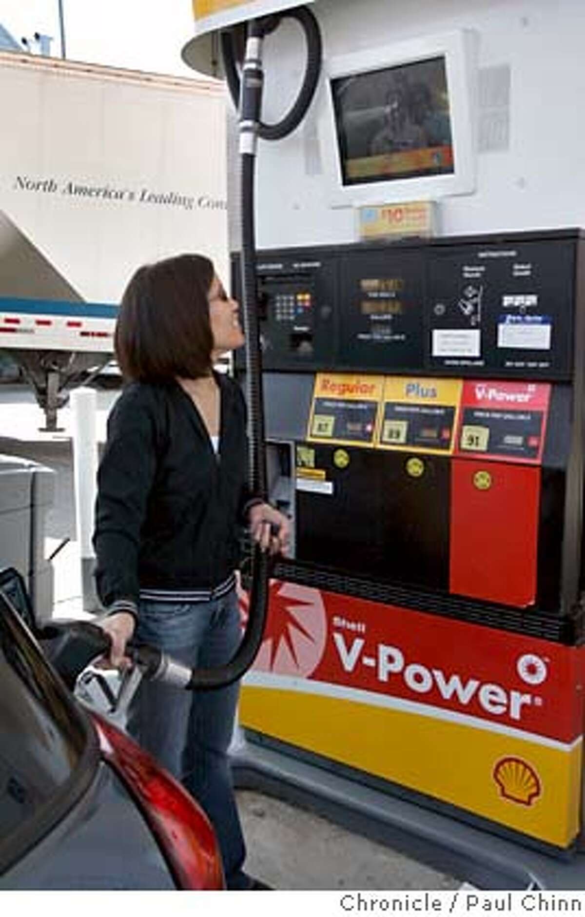Karol Wong fills her tank while watching a video screen displaying advertisements at a Shell station at 7th Avenue and Lincoln in San Francisco, Calif. on Tuesday, March 6, 2007. Shell hopes to have as many as 75 stations equipped with the new video pumps by the end of the month. PAUL CHINN/The Chronicle **Karol Wong MANDATORY CREDIT FOR PHOTOGRAPHER AND S.F. CHRONICLE/NO SALES - MAGS OUT