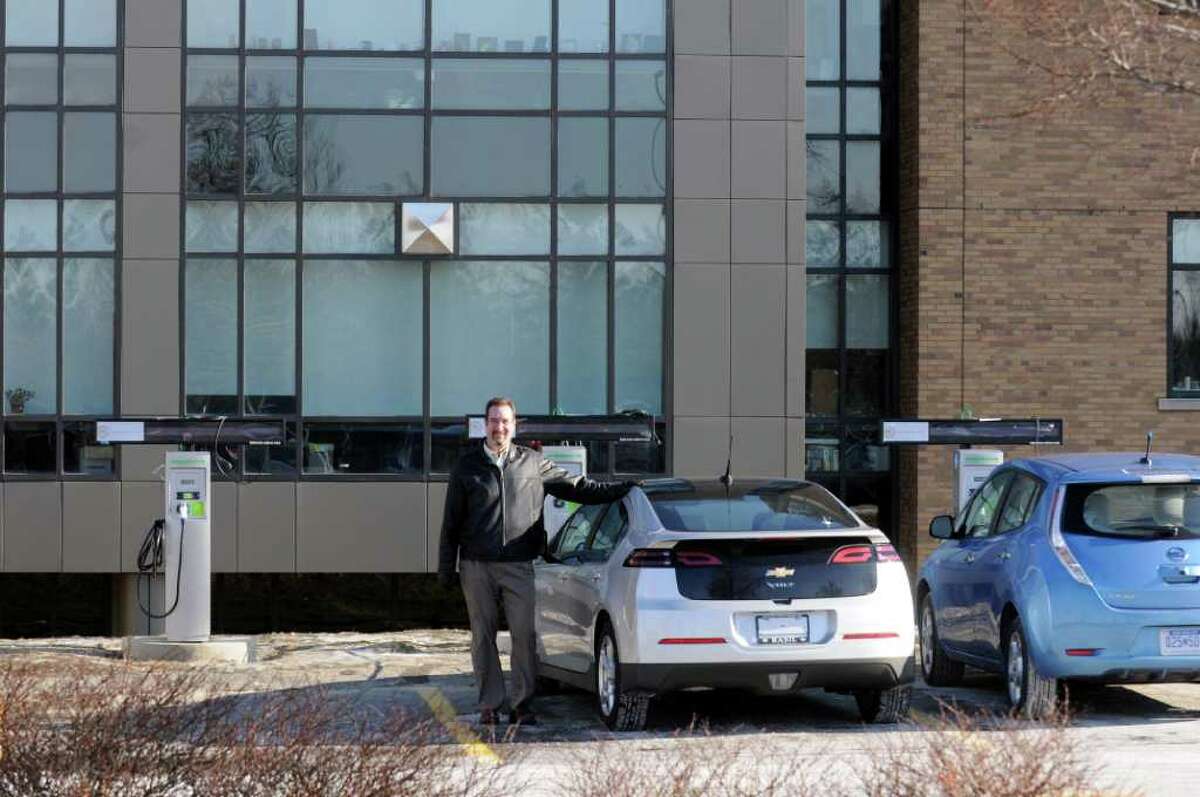 Matt Nielsen , principal scientist EV research , at GE Global Research at the five electric car charging stations in Niskayuna,NY Wednesday, Jan.18, 2012. The electric vehicles pictured are the Chevy Volt and Nissan LEAF.( Michael P. Farrell/Times Union)