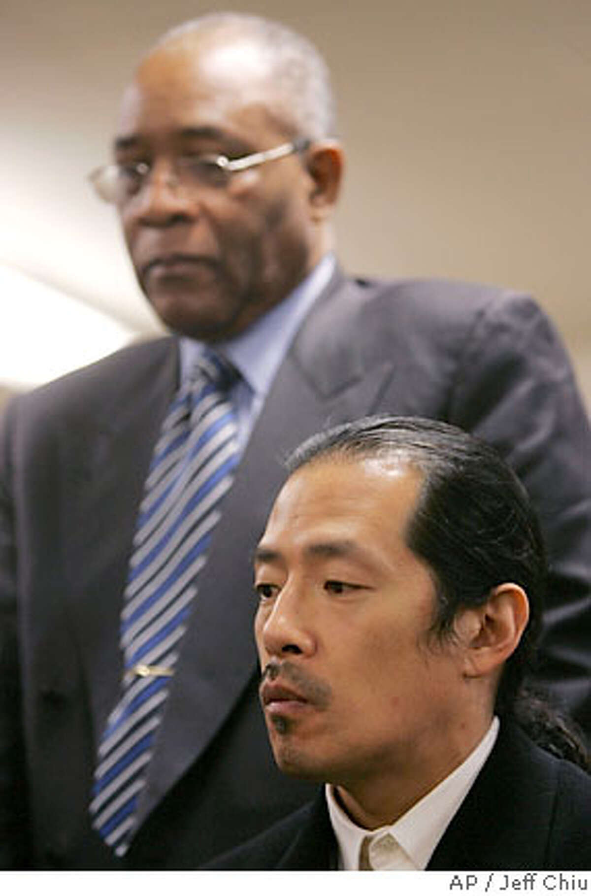 AsianWeek's editor-at-large Ted Fang, foreground, and Rev. Amos Brown, listen to a speaker at a news conference in San Francisco, Wednesday, Feb. 28, 2007. An editor of the weekly newspaper calling itself ''The Voice of Asian America'' apologized and suspended a columnist after Asian-American and city leaders condemned an opinion piece titled ''Why I Hate Blacks.'' Fang called the decision to publish contributor Kenneth Eng's piece a ''mistake'' and held a news conference with NAACP leaders to discuss how the Asian and black communities ''can be different and yet get along and work together.'' (AP Photo/Jeff Chiu)