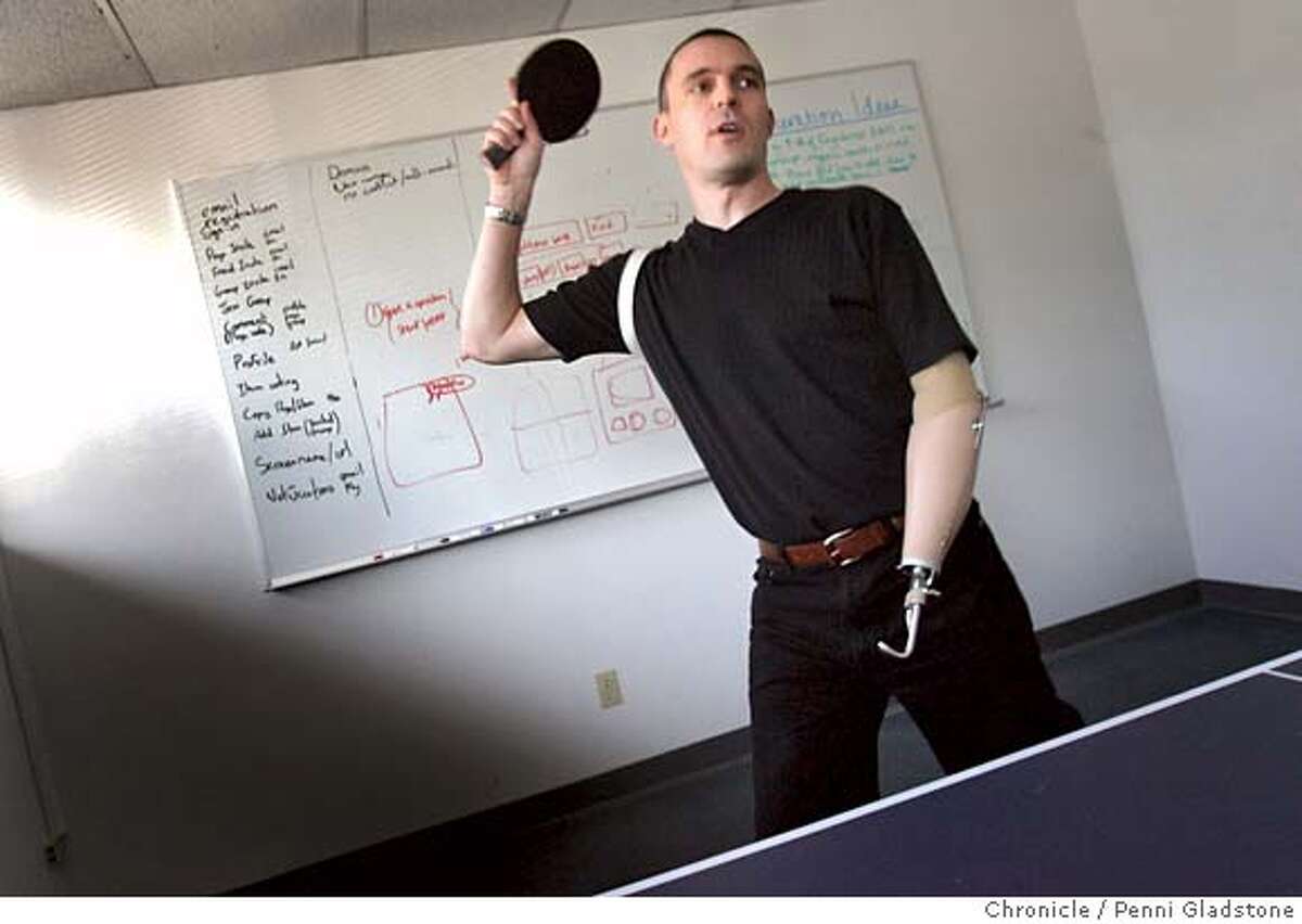 ONEHAND McCammon shows off his ping pong skills with a workmate at the office. Keiron McCammon, the 35-year-old cofounder of Kabooble, an Internet company, was paragliding in Columbia when he hit power lines, badly burning his left hand. Many surgeries could not save his hand and he had to have the hand amputated. Despite months of recovery, he's back at work fulltime. Event on 12/5/06 in Santa Clara. Penni Gladstone / The Chronicle MANDATORY CREDIT FOR PHOTOG AND SF CHRONICLE/NO SALES-MAGS OUT