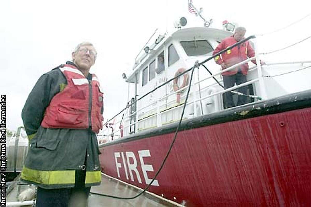 Oakland fire station 2, which is on the waterfront, next to the Port of Oakland, is on Brown's list of closures. Here, (L) Captain Jim DeLacy and (R) Mark Meiers, Marine Engineer, refuel the only Oakland fireboat, the Sea Wolf. Out of the window is Brad Harger, the Marine Pilot. Mayor Jerry Brown unveils his budget cuts. . Shot on 5/2/03 in Oakland. CHRISTINA KOCI HERNANDEZ / The Chronicle