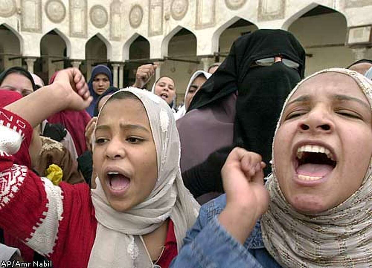 Egyptian women shout anti-U.S. slogans following Friday prayers inside Al-Azhar mosque, the highest Islamic Sunni inistitution, in Cairo, Friday, April 18, 2003. Hundreds of worshippers demonstrated against the U.S.-led war against Iraq. (AP Photo/Amr Nabil)