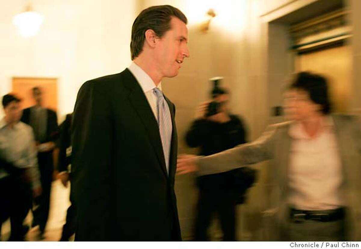 Mayor Gavin Newsom is rushed through a gauntlet of reporters on his way to attend a kick-off ceremony for Black History Month at City Hall in San Francisco, Calif. on Friday, Feb. 2, 2007 one day after acknowledging an affair with the wife of his former campaign manager Alex Tourk. PAUL CHINN/The Chronicle