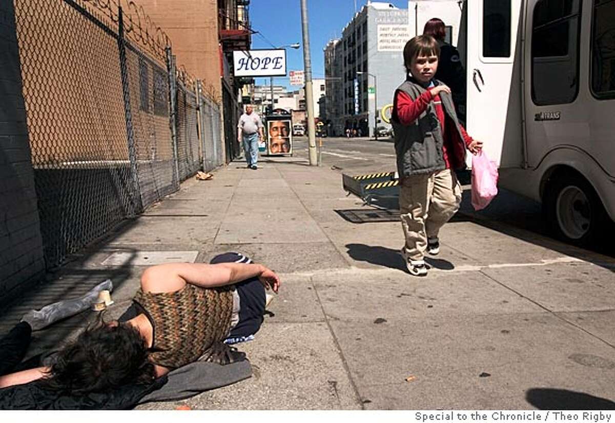 Daragh Hughes (7), passes a homeless woman passed out on Turk St. Photo by Theo Rigby/Special to The Chronicle -ONE TIME USE ONLY-