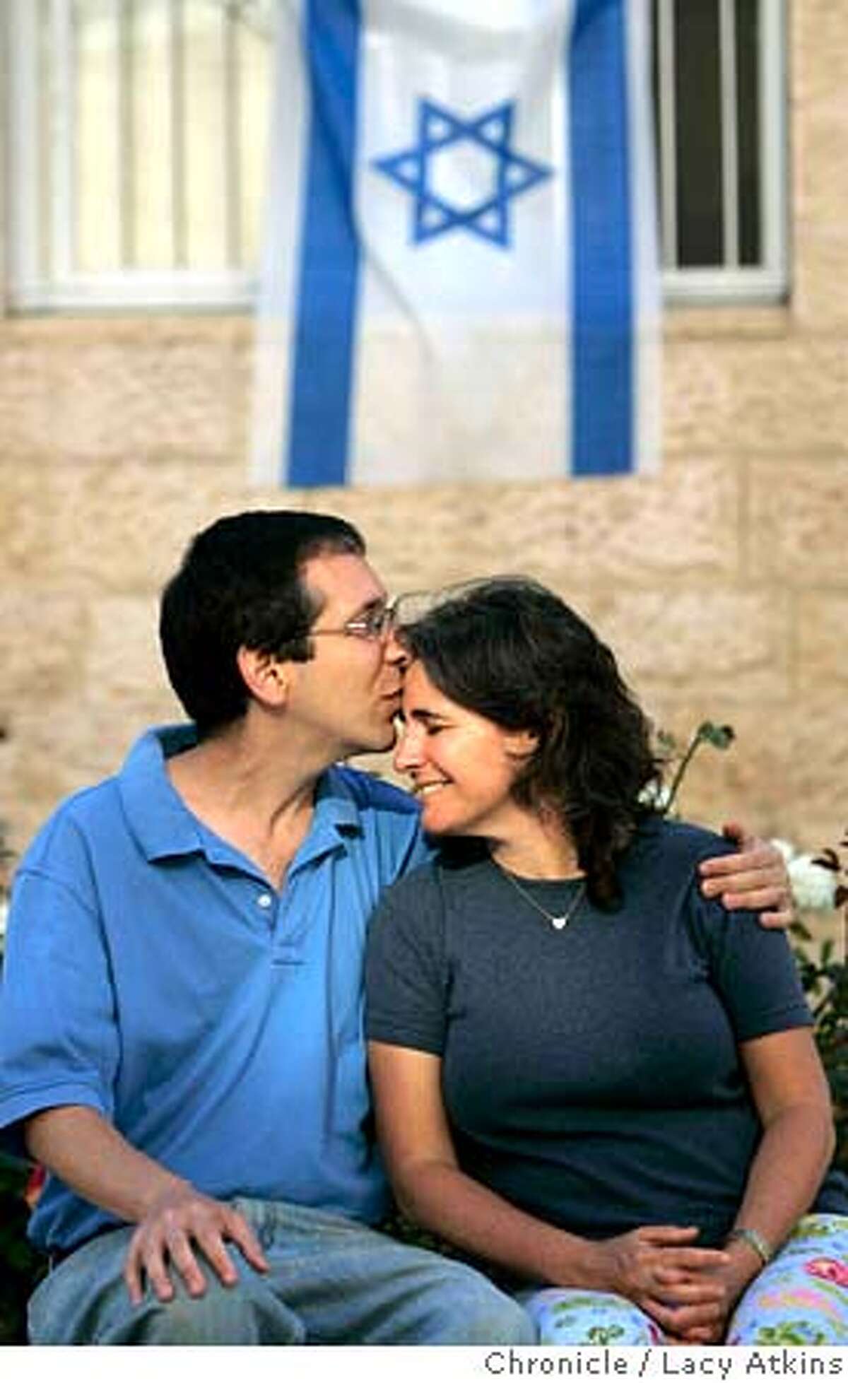 Brian Blum with his wife Jody, at home in Jerusalem, June 16, 2005, in Israel. Brian is from Berkeley and followed his roots to Israel. He's just a normal guy with the exception that his cousin, Marla Bennett was killed in a cafe by a suicide bomber and a bus blow-up along his jogging route moments before he was there. Photographer Lacy Atkins