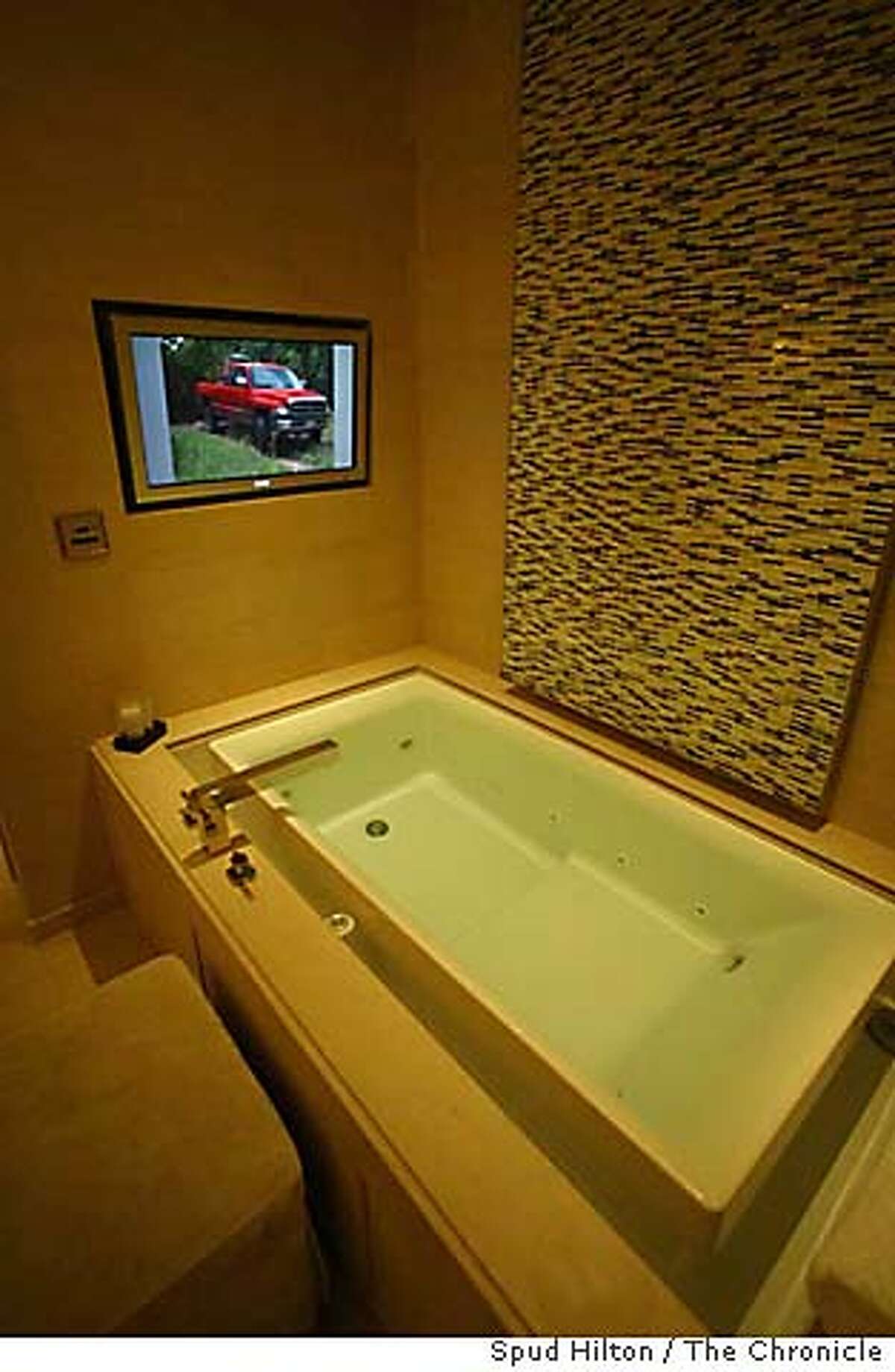 The master bathroom in the Skylofts at MGM Grand are equipped with an "infinity bathtub" that has its own TV with premium cable. Chronicle photo by Spud Hilton